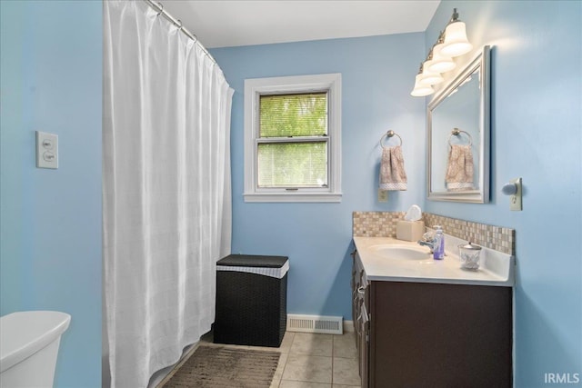 bathroom featuring tile patterned floors, visible vents, toilet, vanity, and baseboards