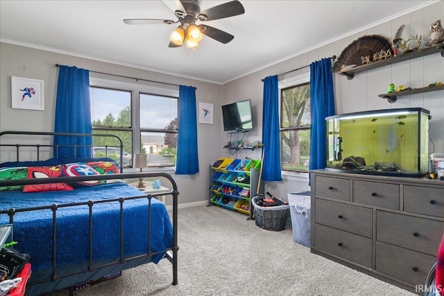 bedroom with a ceiling fan, carpet flooring, baseboards, and ornamental molding