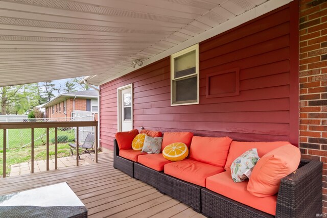 wooden terrace featuring fence and outdoor lounge area
