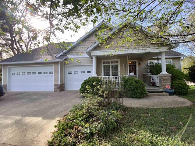 3201 E Kristen Ct, Bloomington, IN 47401 - craftsman-style house featuring an attached garage, stone siding, concrete driveway, and covered porch
