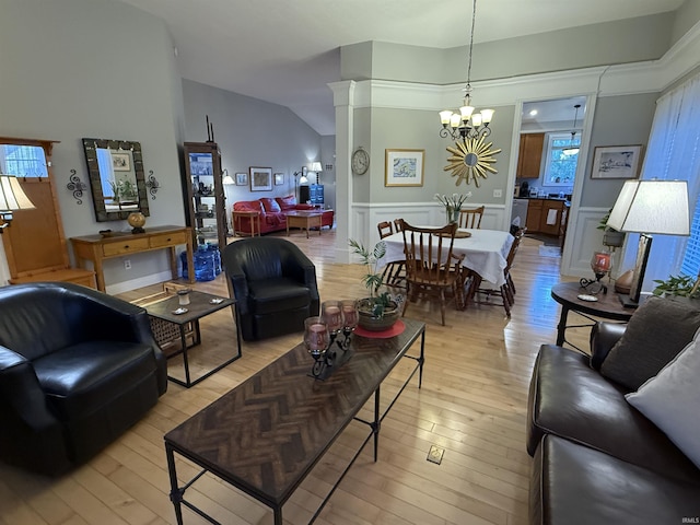 3201 E Kristen Ct, Bloomington, IN 47401 - living area with lofted ceiling, a wainscoted wall, a chandelier, and light wood-style floors