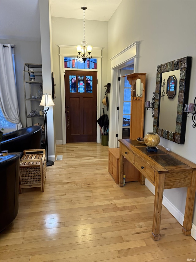 3201 E Kristen Ct, Bloomington, IN 47401 - foyer entrance featuring baseboards, an inviting chandelier, and light wood-type flooring