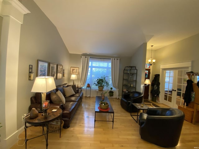 3201 E Kristen Ct, Bloomington, IN 47401 - living area with vaulted ceiling, baseboards, a notable chandelier, and light wood-style flooring