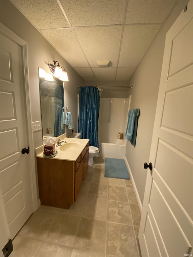 3201 E Kristen Ct, Bloomington, IN 47401 - full bath with tile patterned floors, vanity, shower / bathtub combination with curtain, toilet, and a paneled ceiling
