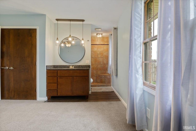 1689 E 550 Rd S, Peru, IN 46970 - corridor with dark carpet, an inviting chandelier, a sink, and a wealth of natural light