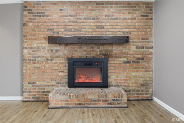 1689 E 550 Rd S, Peru, IN 46970 - room details with wood finished floors, baseboards, and a brick fireplace