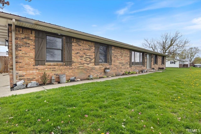 1689 E 550 Rd S, Peru, IN 46970 - view of property exterior featuring a lawn and brick siding