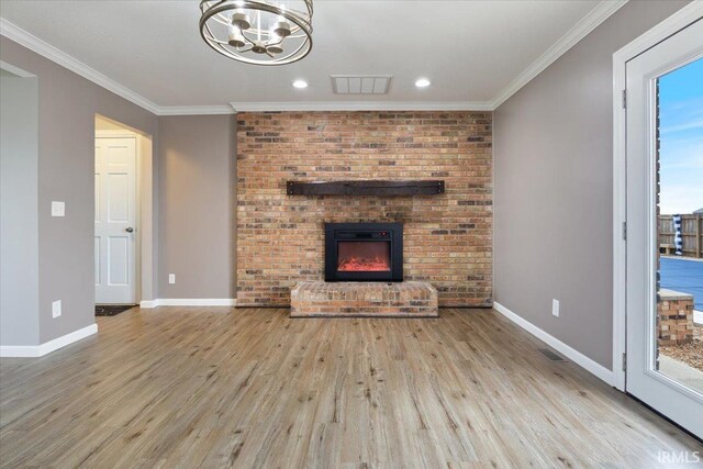 1689 E 550 Rd S, Peru, IN 46970 - unfurnished living room featuring a fireplace, wood finished floors, visible vents, and baseboards