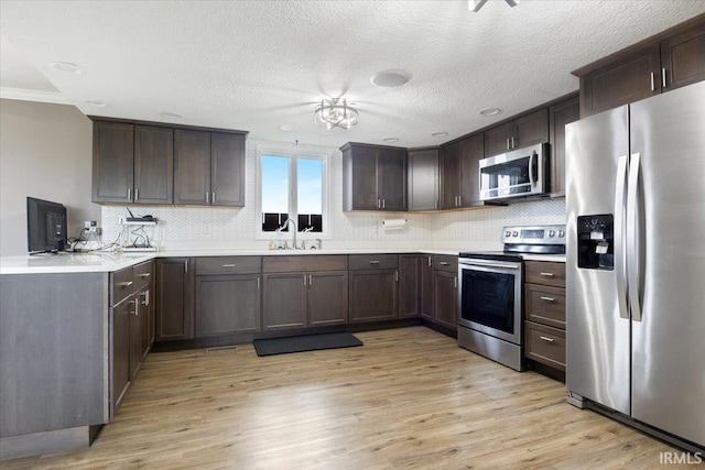 1689 E 550 Rd S, Peru, IN 46970 - kitchen with backsplash, dark brown cabinetry, and stainless steel appliances