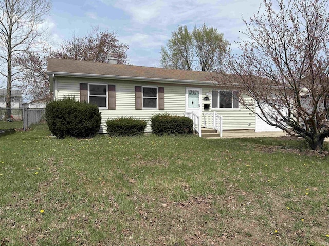 view of front of home featuring a chimney, a front yard, and fence