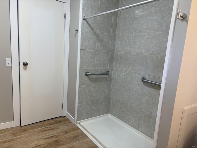 full bathroom with wood finished floors and a stall shower