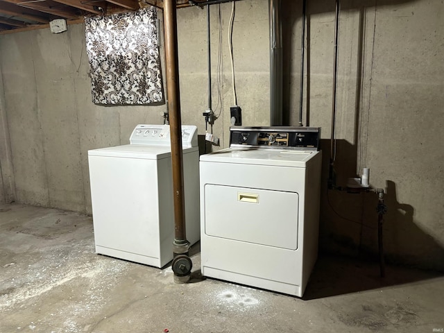 clothes washing area with washing machine and clothes dryer and laundry area