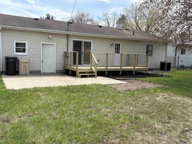 rear view of property featuring a yard, central air condition unit, a patio area, and a deck