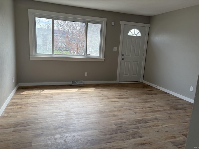 entrance foyer featuring wood finished floors, visible vents, and baseboards