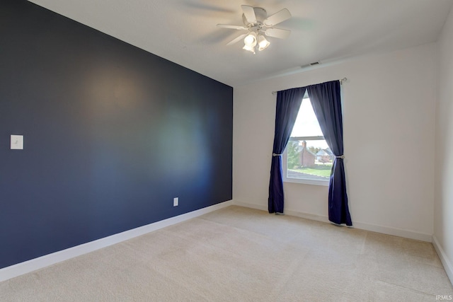 unfurnished room featuring ceiling fan, light carpet, and baseboards