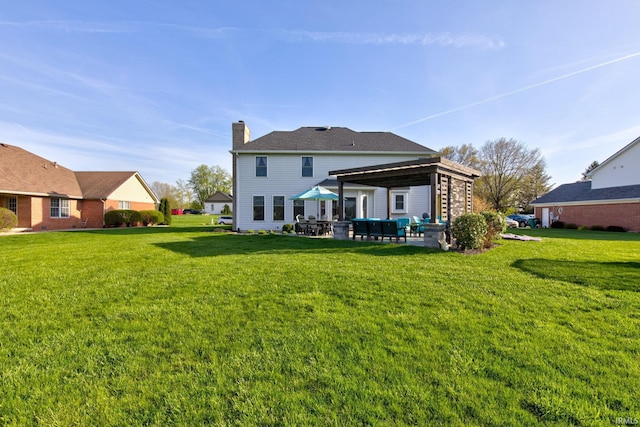 back of property featuring a chimney, a gazebo, a yard, and a patio