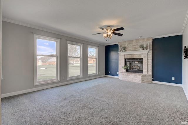 unfurnished living room with plenty of natural light, a ceiling fan, baseboards, and ornamental molding