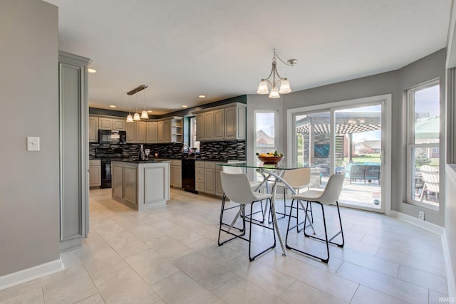 dining room with baseboards, a notable chandelier, and recessed lighting