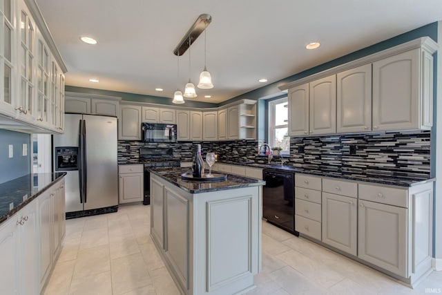 kitchen featuring tasteful backsplash, glass insert cabinets, dark stone counters, and black appliances