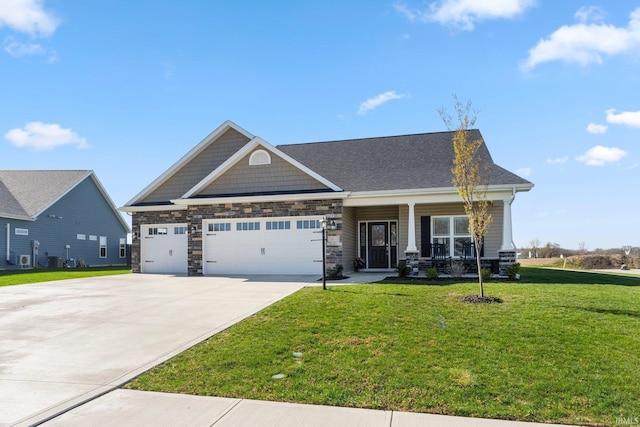 craftsman-style home with a front lawn, concrete driveway, an attached garage, a porch, and stone siding