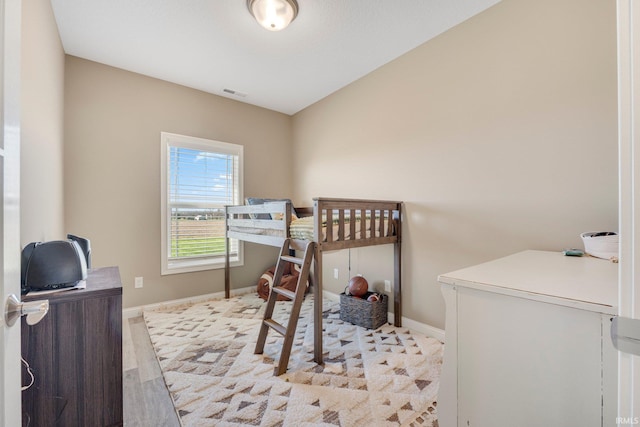 bedroom featuring visible vents and baseboards