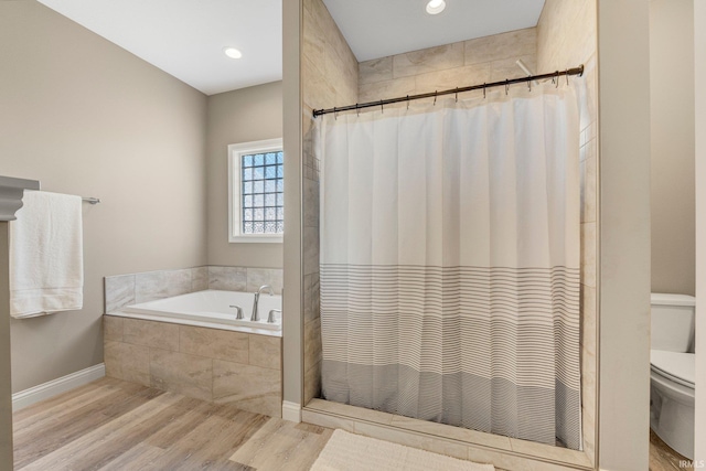 bathroom with wood finished floors, a bath, a shower with curtain, toilet, and recessed lighting