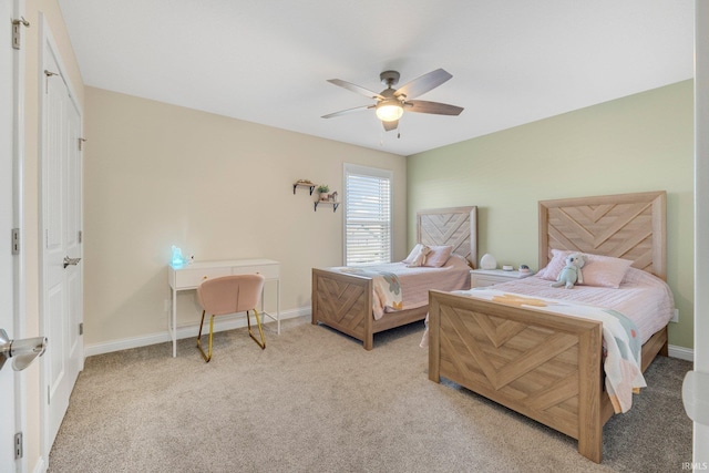 bedroom featuring light carpet, baseboards, and ceiling fan
