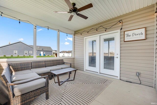 sunroom featuring ceiling fan and an outdoor living space