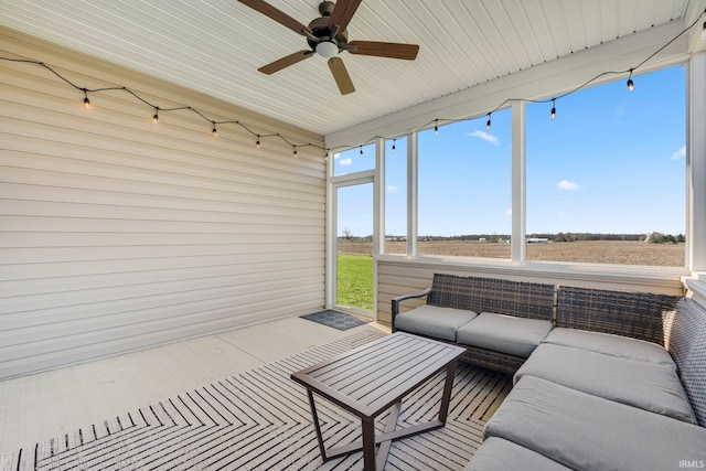 sunroom with outdoor lounge area and a ceiling fan