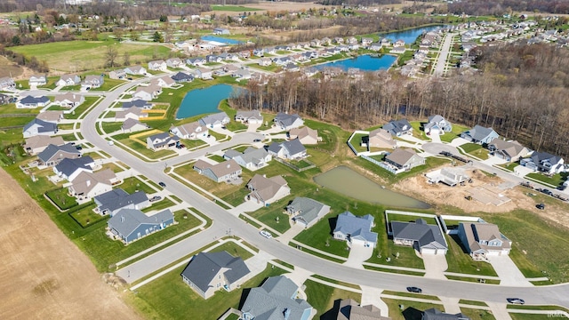drone / aerial view featuring a residential view and a water view