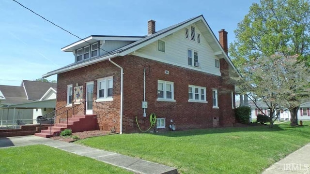 view of home's exterior featuring a chimney, brick siding, and a yard