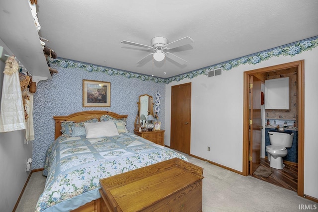 bedroom featuring visible vents, a closet, baseboards, light colored carpet, and ceiling fan