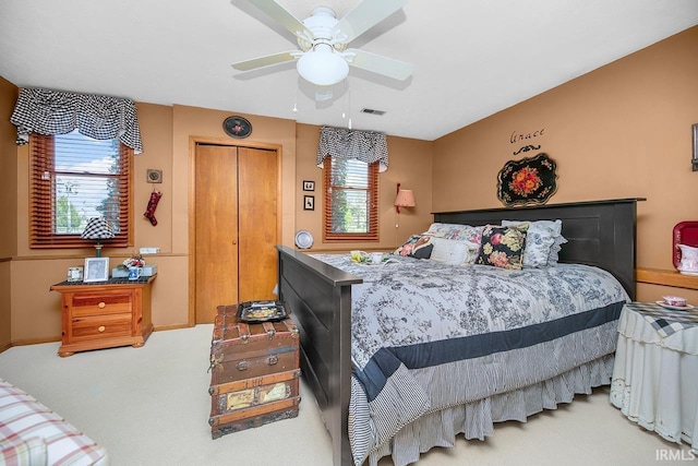 bedroom with a ceiling fan, visible vents, and carpet