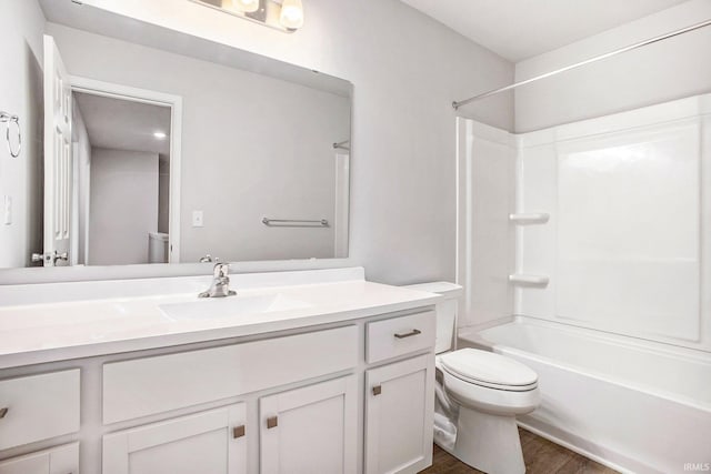 full bath featuring shower / washtub combination, wood finished floors, vanity, and toilet