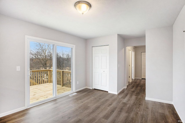 interior space with wood finished floors and baseboards