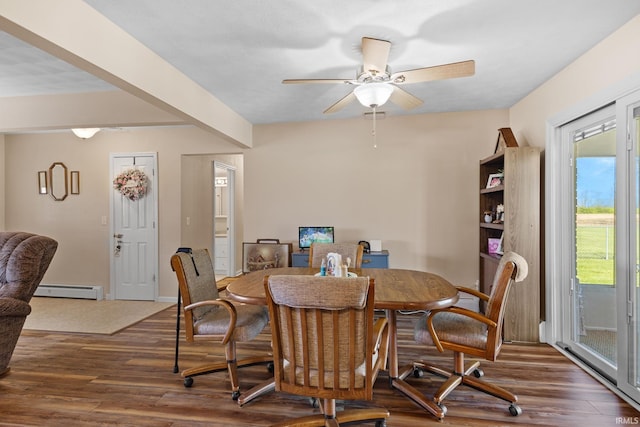 dining room featuring a baseboard heating unit, baseboards, wood finished floors, and ceiling fan