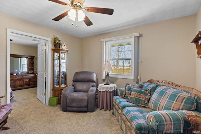carpeted living room featuring a ceiling fan and visible vents