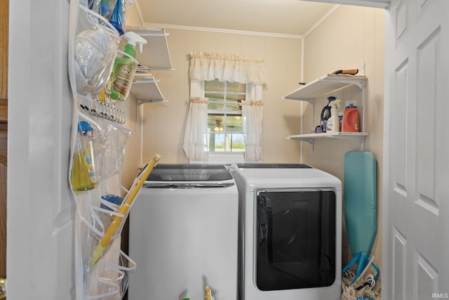 washroom featuring washer and dryer, laundry area, and ornamental molding