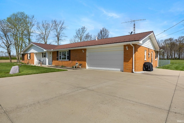 ranch-style house with a garage, concrete driveway, a front lawn, metal roof, and brick siding