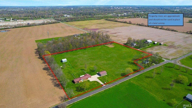 birds eye view of property with a rural view