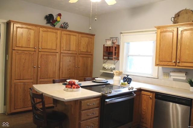 1185 N 10th St, Noblesville, IN 46060 - kitchen with brown cabinets, a peninsula, stainless steel appliances, and light countertops