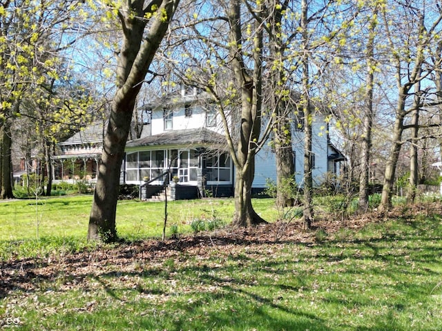 1185 N 10th St, Noblesville, IN 46060 - view of front of property featuring a sunroom and a front yard