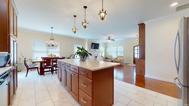 3512 Forestdale Dr, Newburgh, IN 47630 - kitchen featuring visible vents, ornamental molding, freestanding refrigerator, a center island, and ceiling fan with notable chandelier