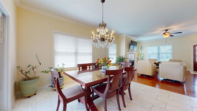 3512 Forestdale Dr, Newburgh, IN 47630 - dining space with ceiling fan with notable chandelier, baseboards, a fireplace, and crown molding