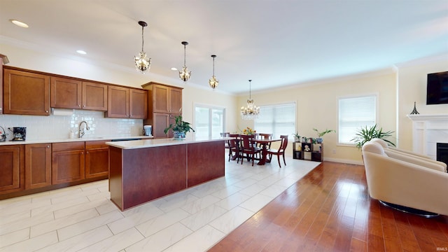 3512 Forestdale Dr, Newburgh, IN 47630 - kitchen with brown cabinets, light countertops, a notable chandelier, and ornamental molding