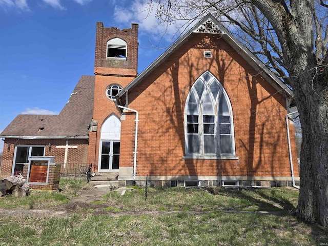 rear view of property with brick siding