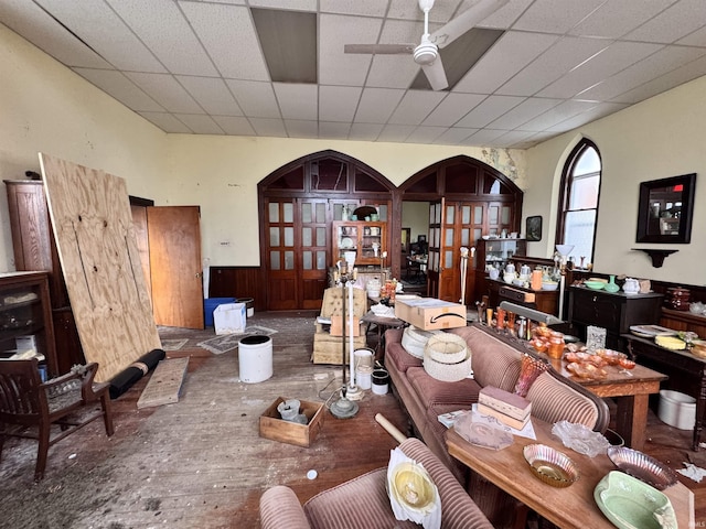 dining space featuring arched walkways, a ceiling fan, hardwood / wood-style flooring, and french doors