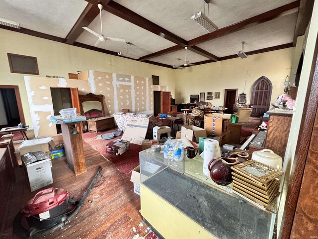 interior space with beamed ceiling, a ceiling fan, wood finished floors, and coffered ceiling