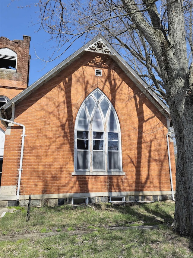 view of side of property with brick siding