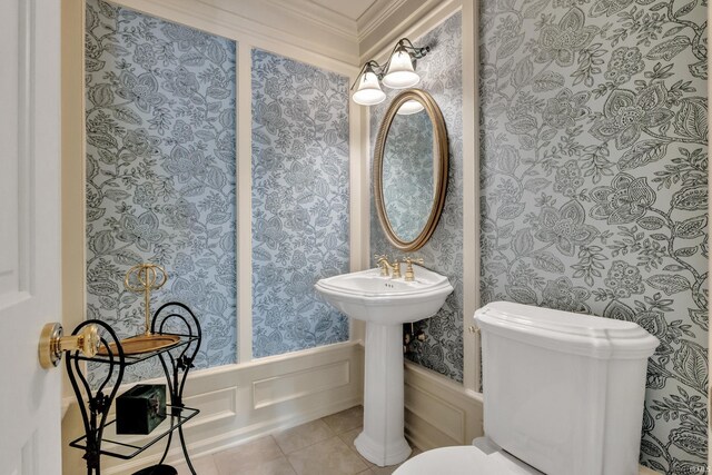 2818 Little Turtle Trl, Fort Wayne, IN 46804 - bathroom with wallpapered walls, toilet, ornamental molding, a decorative wall, and wainscoting